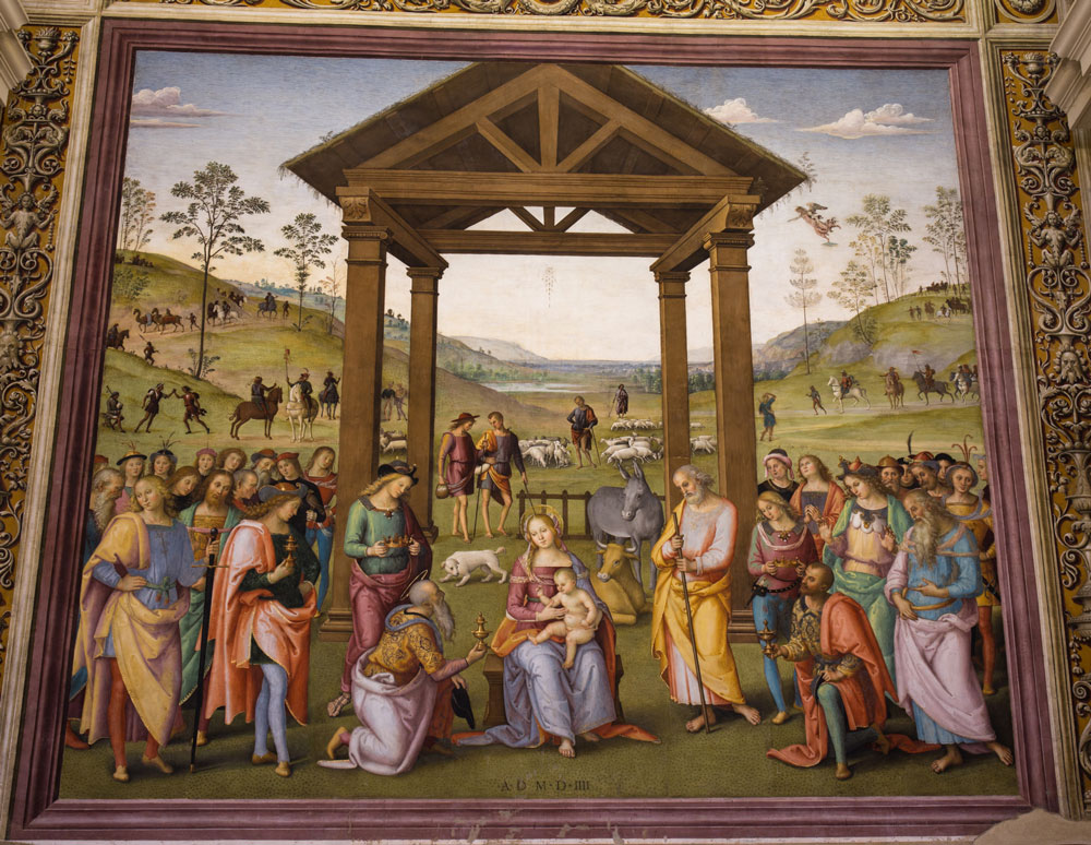 visione d’insieme dell’affresco, con la Natività al centro, i Re Magi e il loro seguito ai lati in primo piano e, sullo sfondo, i pastori con le loro greggi in un paesaggio idilliaco, fatto di dolci colline, pochi alberi e uno specchio d’acqua al centro in lontananza.