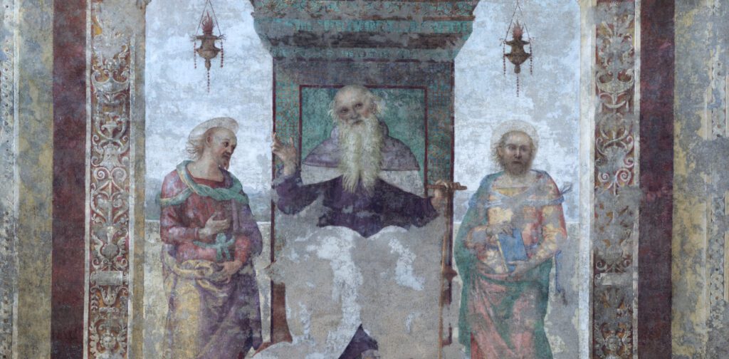 Detail of the fresco by Perugino entitled "Saint Anthony Abbot between Saints Paul the Hermit and Marcellus" and preserved inside the Church of Saints Peter and Paul in Città della Pieve. In the main scene, Saint Anthony Abbot is painted in the centre, seated on an elegant raised throne from which two lanterns hang. While looking intently at the observer, the Saint has his right hand raised and his left hand resting on his stick, an object with which he is usually depicted in sacred paintings. Saint Anthony Abbot is flanked by Saint Paul the Hermit and Saint Marcellus, as indicated by the inscription at the base of the throne. In 1861, an earthquake hit the church and damaged the fresco. The work was then transferred to a canvas and restored, but it was not possible to restore it to its original state due to colour fading in much of the artwork.