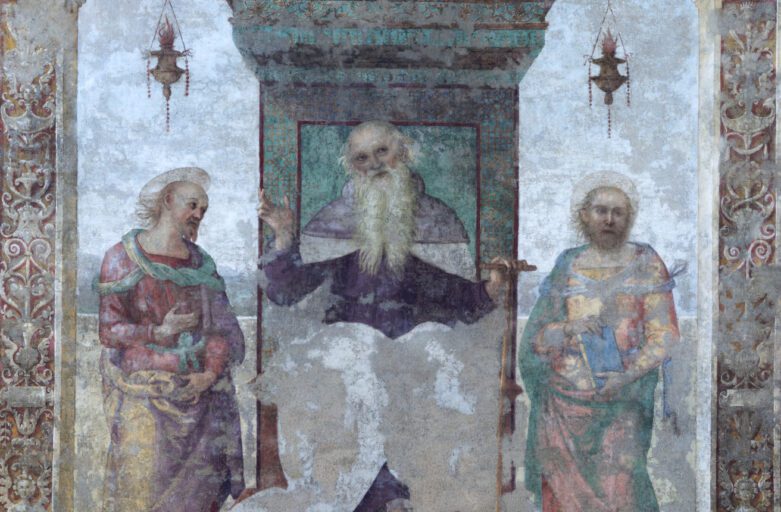 Detail of the fresco by Perugino entitled "Saint Anthony Abbot between Saints Paul the Hermit and Marcellus" and preserved inside the Church of Saints Peter and Paul in Città della Pieve. In the main scene, Saint Anthony Abbot is painted in the centre, seated on an elegant raised throne from which two lanterns hang. While looking intently at the observer, the Saint has his right hand raised and his left hand resting on his stick, an object with which he is usually depicted in sacred paintings. Saint Anthony Abbot is flanked by Saint Paul the Hermit and Saint Marcellus, as indicated by the inscription at the base of the throne. In 1861, an earthquake hit the church and damaged the fresco. The work was then transferred to a canvas and restored, but it was not possible to restore it to its original state due to colour fading in much of the artwork.