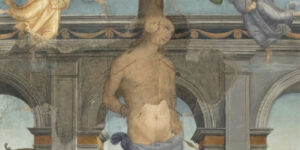 Dettaglio del corpo e del viso di San Sebastiano trafitto da frecce, dipinto dal Perugino nella Pala Martinelli.